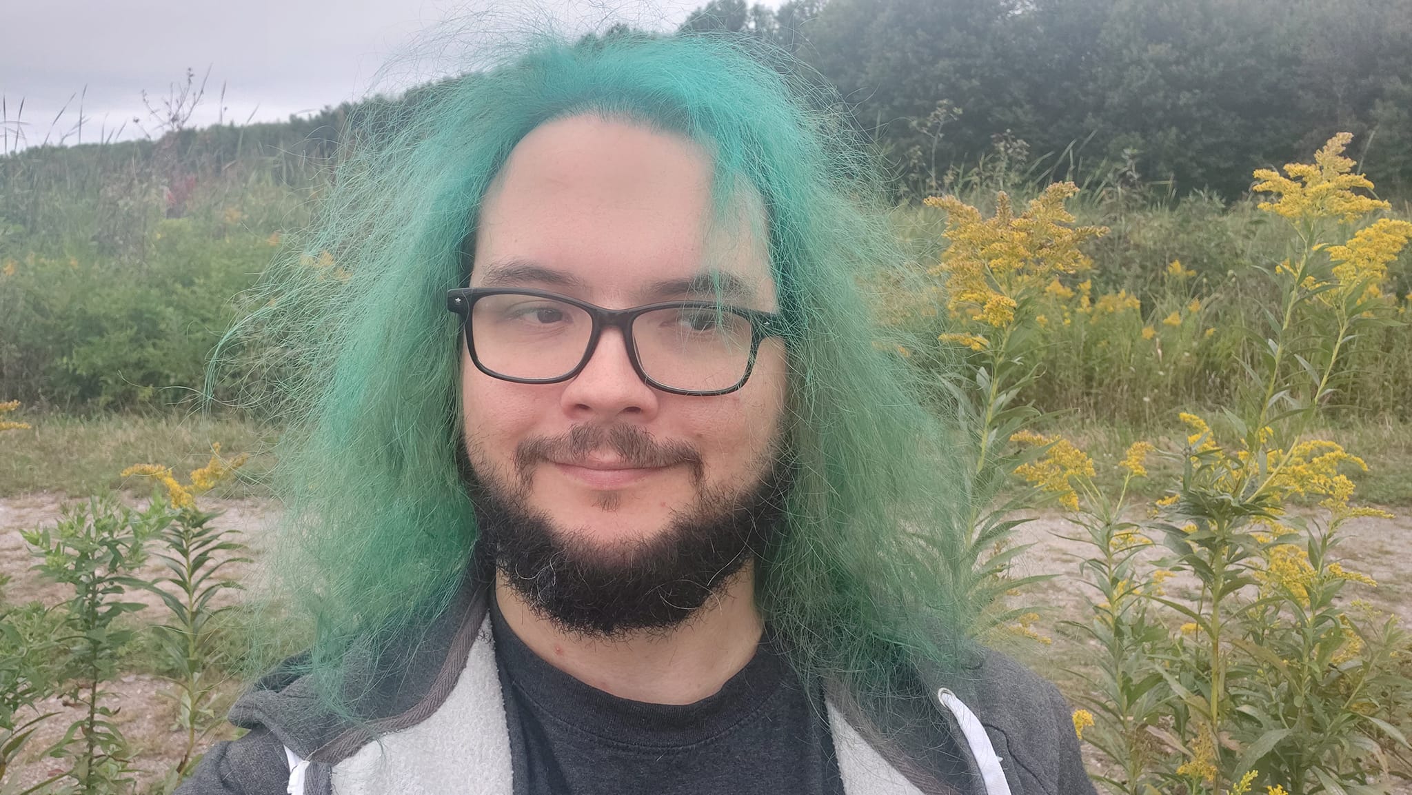 A man with green hair is visiting a freshwater marsh, photo 3